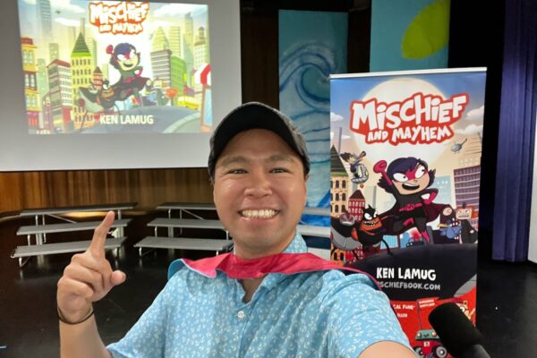 Ken at a school auditorium presentation